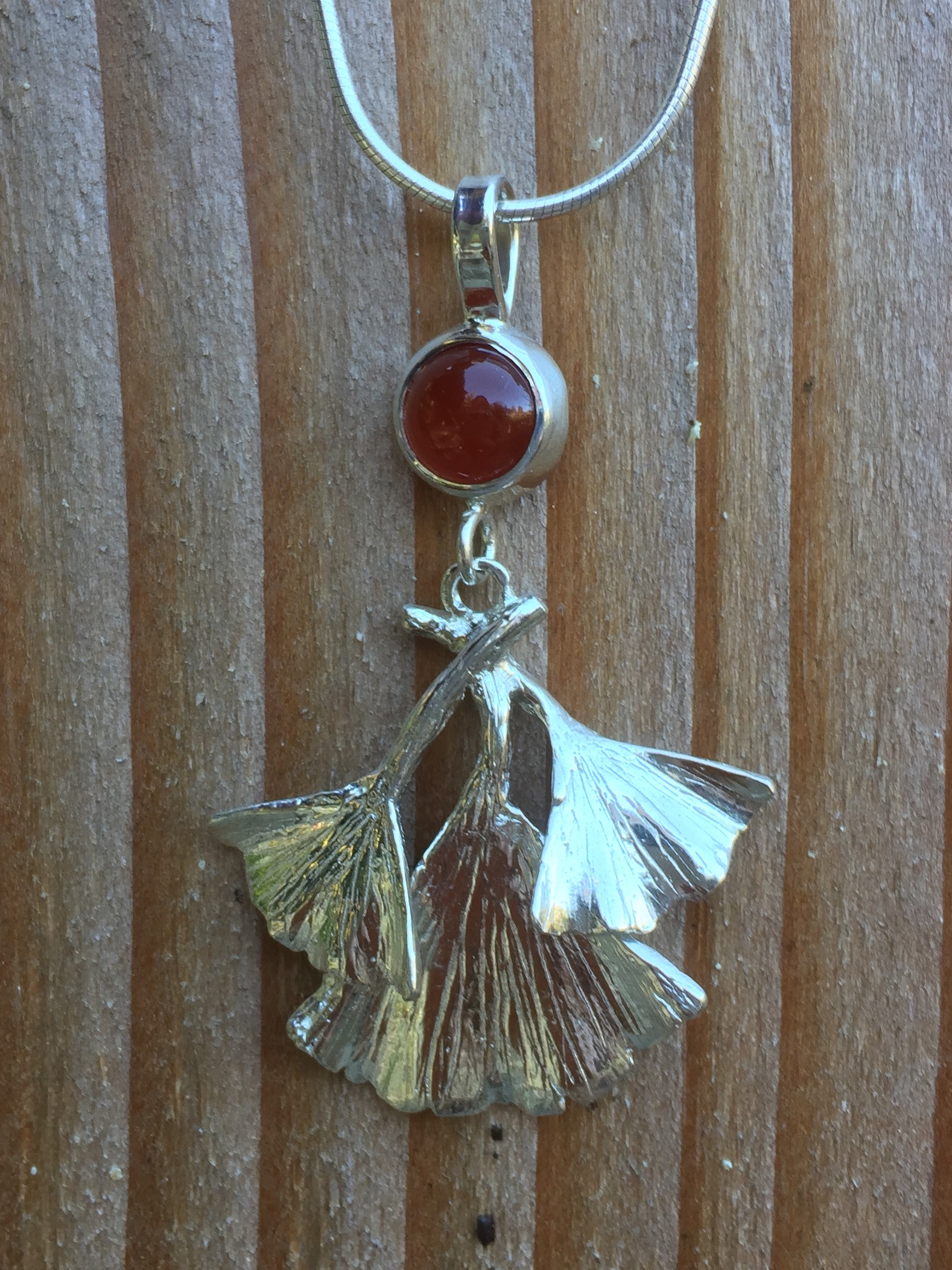 Zoom in on Red carnelian cabochon stone and silver gingko tree leaves necklace pendant