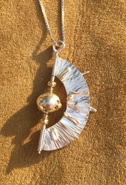 gold and silver pendant rotating bal and sail sundial